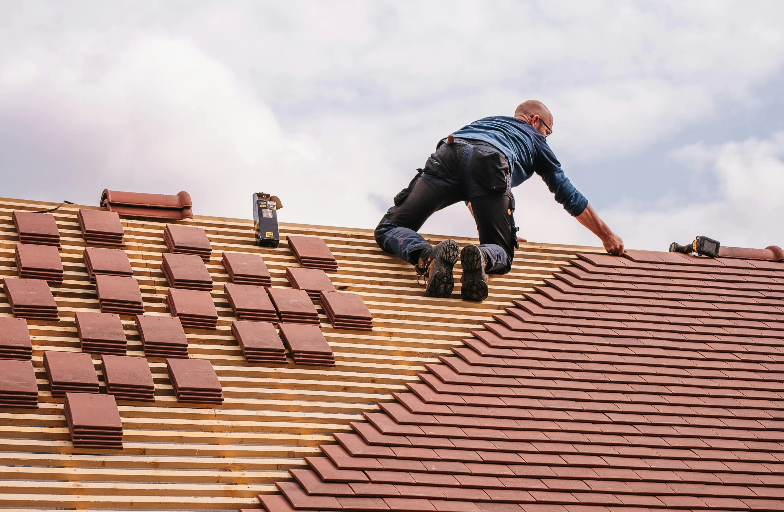 image of a man working on a roof