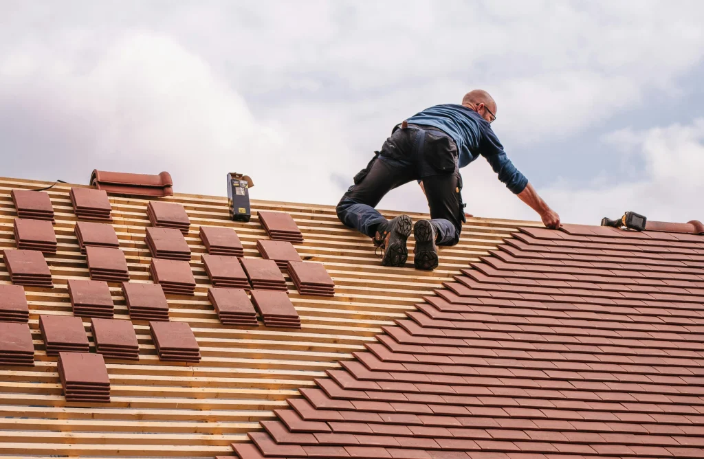 roofer from a roofing company Milton Keynes fixing a roof